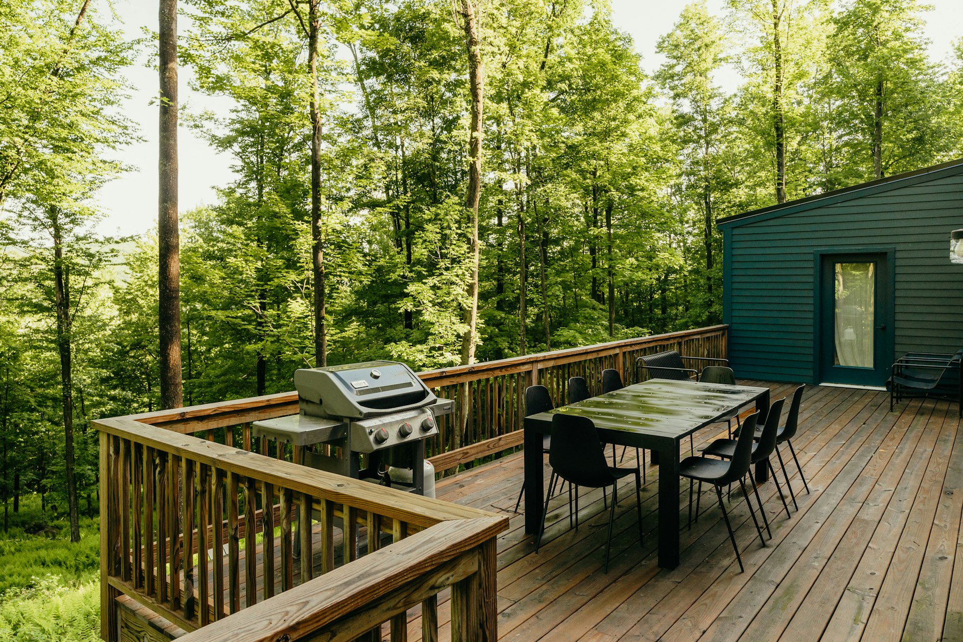 a wooden deck with a table and chairs on it